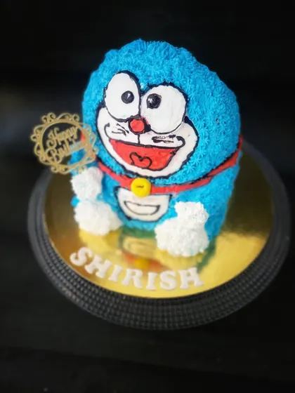 Our Doraemon cake uses the blue character theme for a birthday design, shown here in a still photograph.