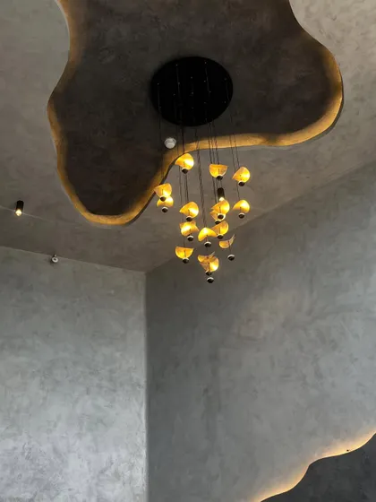 A closer look at the dramatic ceiling detail. The recessed cove lighting follows the custom-designed organic shape, creating a soft glow that highlights the room's unique architecture.