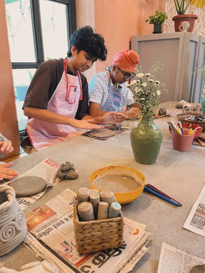 This is a typical scene from one of our kids' birthday parties. Everyone is working on their own hand-building project, from coil pots to little sculptures.