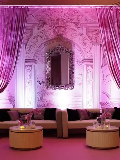 Another angle of the pink lounge, showcasing the dramatic drapes and the sophisticated arrangement of seating designed for conversation and comfort.