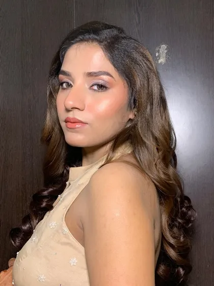 A close-up of soft, bouncy curls with a side part. This style adds volume and frames the face beautifully, suitable for any festive occasion.