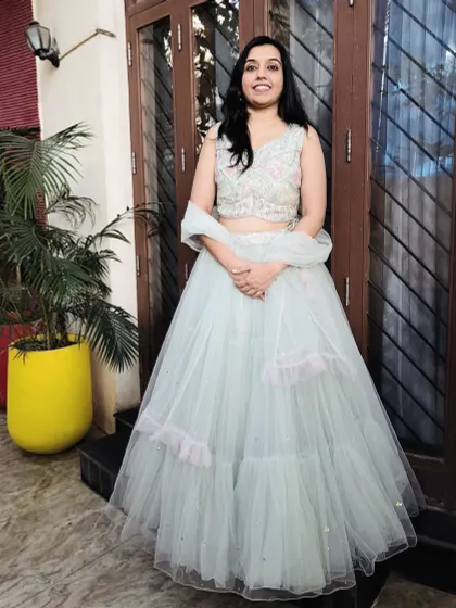 This pastel green lehenga with a multi-color sequin blouse is a beautiful choice for a mehendi or sangeet. The ruffled details on the skirt add a modern and playful touch.