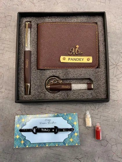 A men's gift set perfect for Rakhi, including a personalized wallet, pen, and keychain, along with a custom name bracelet.