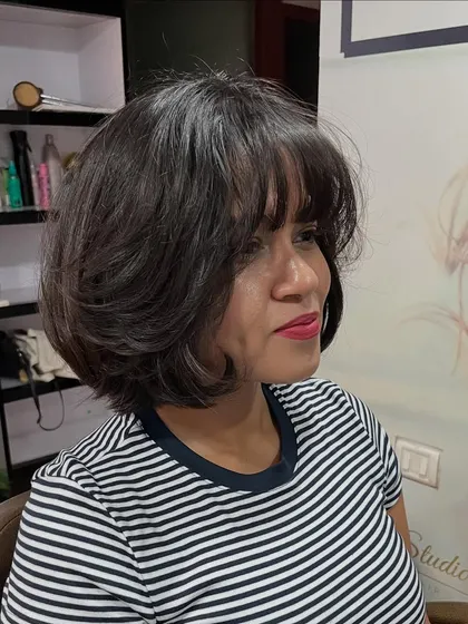 The bangs frame her face beautifully.
