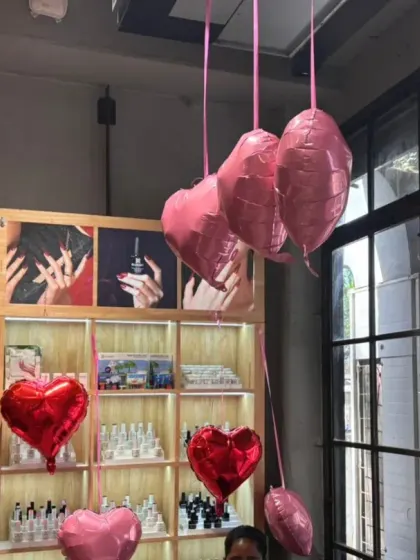 The decorations are designed to enhance, not obstruct. Here, the hanging balloons frame the view of the salon's product displays and service areas, adding to the ambiance without getting in the way.