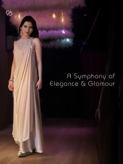 Embrace the enchantment of the night in this show-stopping party gown. The draped silhouette and embellished neckline create an aura of effortless glamour that steals the spotlight.