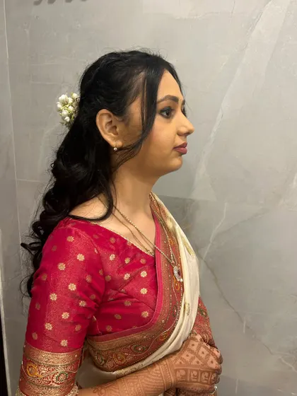 A bridesmaid in a beautiful traditional white and red saree. I gave her a soft makeup look and a curly hairstyle decorated with real mogra flowers.