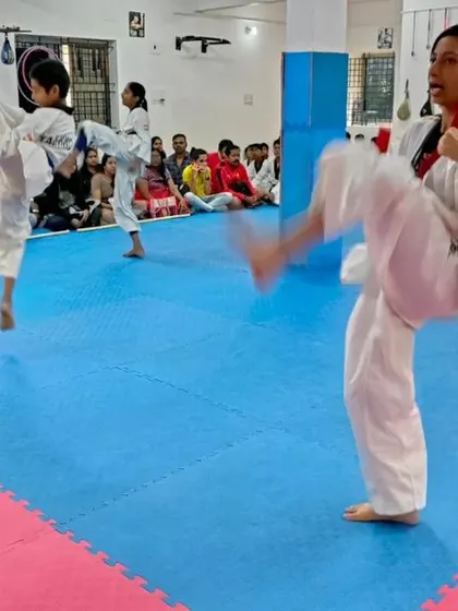 Students practicing jumping kicks.