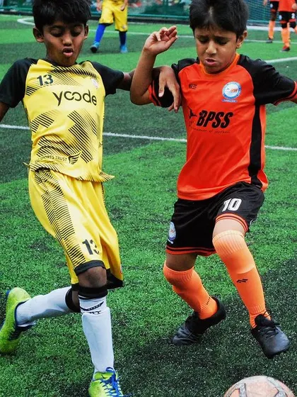 Two U-9 players in a tight contest for the ball. I teach competitive spirit combined with good sportsmanship.
