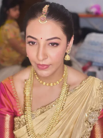 A direct portrait of Gouthami, showing her radiant skin and the classic simplicity of her bridal makeup.