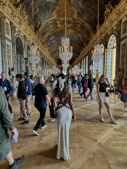 A key part of my philosophy is helping you dress for the life you want. This moment, captured in the iconic Hall of Mirrors at the Palace of Versailles, is all about embodying that main character energy. The elegant backless dress with lace details was perfect for a day of feeling like royalty.