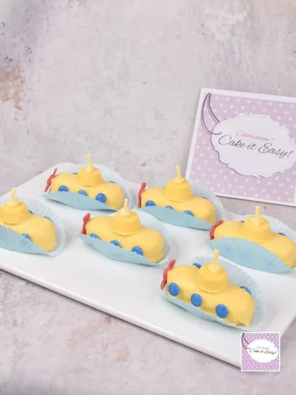 A platter of the yellow submarine mini cakes. These individual treats are perfect for dessert tables and party favors.