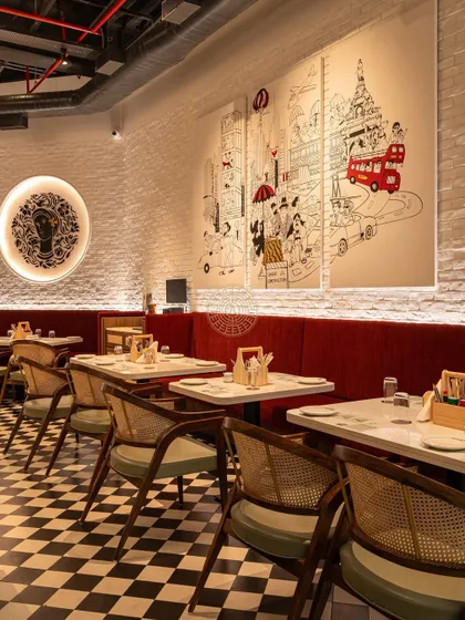 The custom Bombay-themed mural is a key feature, providing a narrative element and a great conversation starter for diners.
