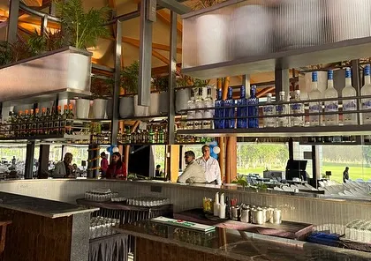 The bar area overlooking the golf course. Our design ensures that the interior landscape feels connected to the exterior, blurring the lines between the built and natural environments for a seamless guest experience.