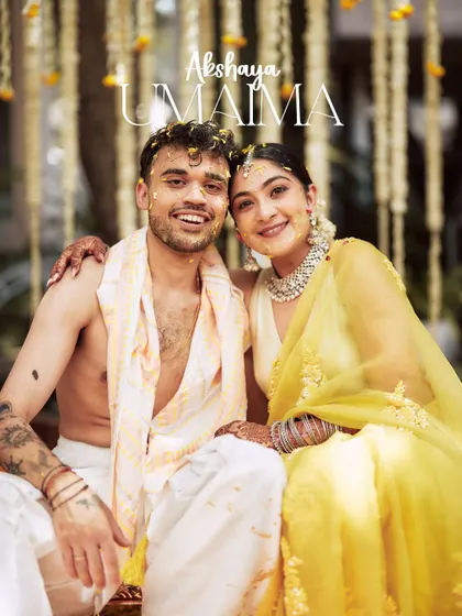 A happy portrait of the couple at their Haldi ceremony. Their smiles are infectious, and the traditional decor provides a beautiful, authentic setting.