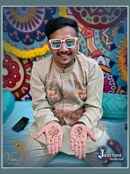 Having a great time at the mehndi party. This groom chose a minimal design with a Ganesh motif and his partner's initial.