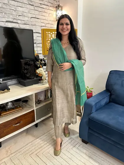 My favorite accessory is a statement necklace. This image showcases a beautiful beige suit paired with a simple green dupatta, allowing the gold necklace to be the star of the show.