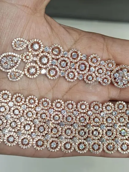 A beautiful rose-gold polished American Diamond choker set. The intricate circular design gives it a very delicate and feminine look. Rose gold is very popular for its modern and subtle appeal.