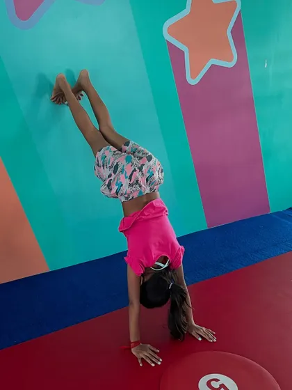 A few snapshots from Day 1 of Summer Camp. Kids are seen practicing handstands, yoga poses, and downward dog, showcasing the variety of activities we offer.