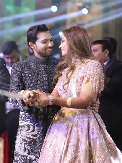 The couple sharing a dance and a laugh during their reception. This candid shot captures their easy chemistry and the happiness they share.