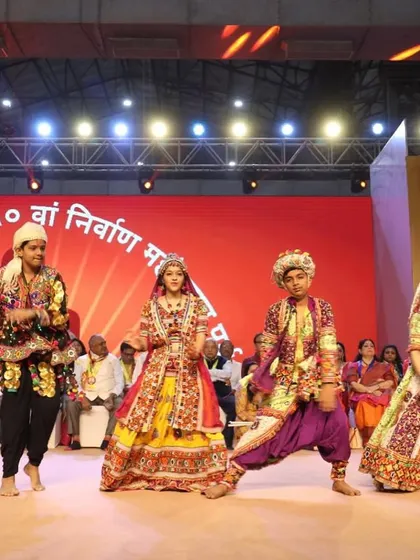 Young performers in vibrant traditional attire perform a cultural dance on stage. We facilitate a diverse range of performances to enrich the event experience.