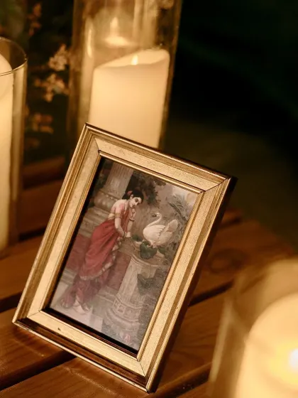 A framed picture of a classic Indian painting adds a touch of art and culture to the Sangeet decor.