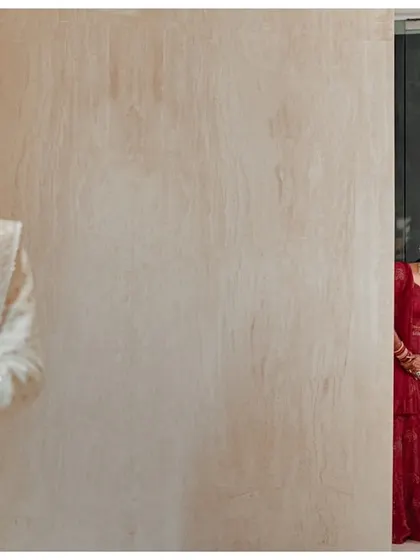The moment of anticipation before the first look. Katyayni peeks from behind a door as Kunal waits, creating a playful and exciting narrative in a single frame.