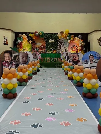 A detailed view of the themed aisle runner with paw prints and personalized photo pillars, making the journey into the party hall a part of the fun.