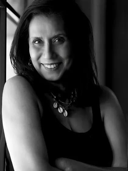 A warm and engaging black and white portrait of Swaroopa Ghosh, showcasing her beautiful smile and expressive eyes.