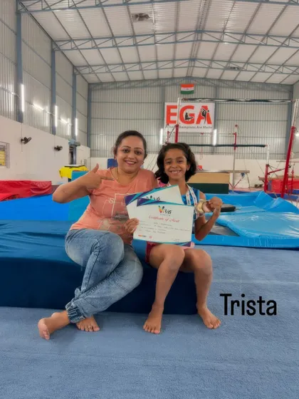 Trista celebrating her well-deserved medal at the VIBGYOR Viva Competition. We support each gymnast's individual journey to success.