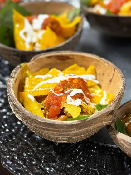 A wholesome and satisfying meal in a bowl. Our Burrito Rice Bowl is layered with zesty rice, hearty beans, fresh vegetables, and tangy salsa, served in a natural coconut shell for a rustic touch.