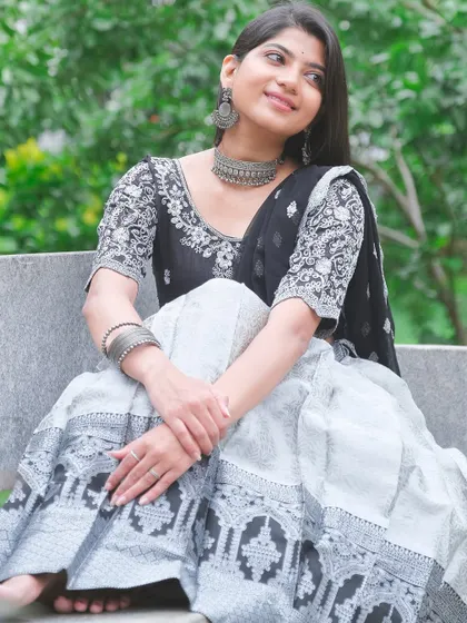 A full-length shot of a black and white lehenga, perfect for a sophisticated evening look. The detailed embroidery on the blouse and the flowing skirt are the highlights of this outfit.
