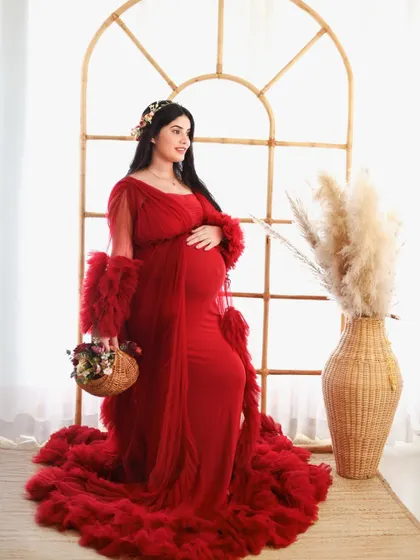 A beautiful shot featuring a flowing red gown against our arched window prop. The natural light and boho elements combine for a soft and romantic portrait.