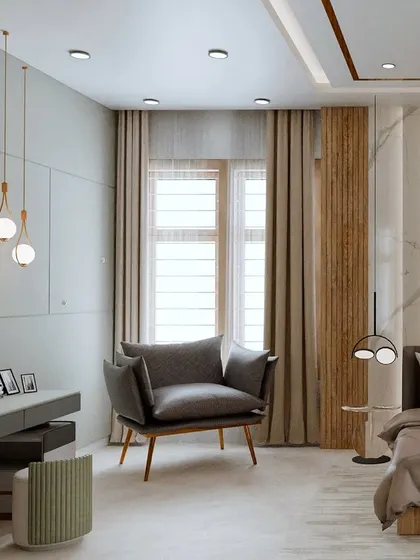 This angle highlights the cozy reading chair and dressing table area. The combination of different materials and thoughtful lighting creates a functional and beautiful personal space within the bedroom.