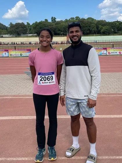 Our record-breaking hurdler with her coach. She not only won her first gold medal in 80m hurdles but also set a new meet record.