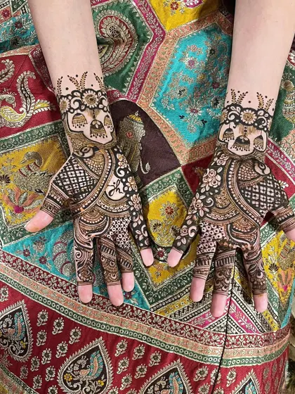 This design is perfect for a wedding guest, with jhumka (earring) and elephant motifs. It's festive and traditional without being as heavy as a full bridal design.