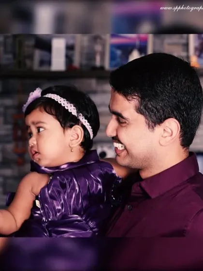 A father holding his baby girl provides a sense of scale and connection. We focus on capturing these gentle, interactive moments between parents and their children.