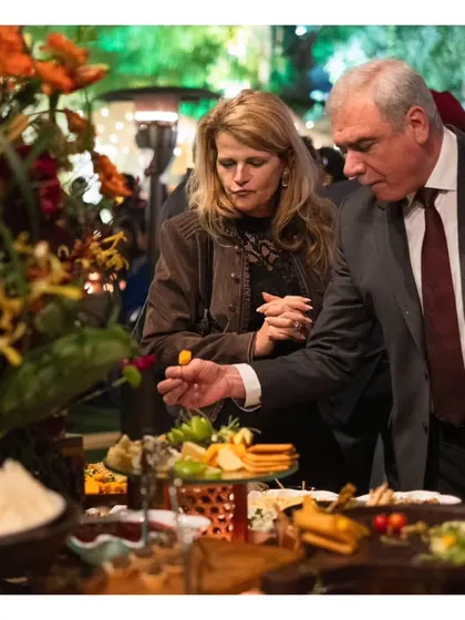 Guests interacting with our grazing table, selecting from a wide array of choices. Our setups are designed to be both beautiful and user-friendly.