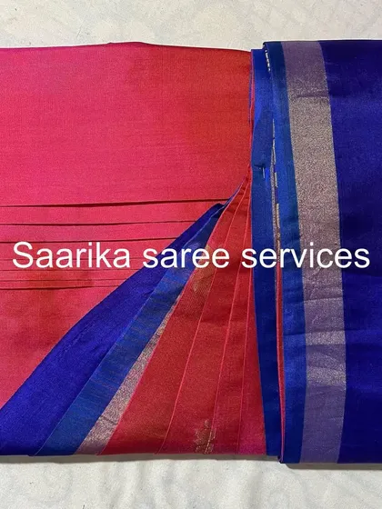 A beautiful pink and blue silk saree, pleated and ready. This color combination is perfect for daytime events.