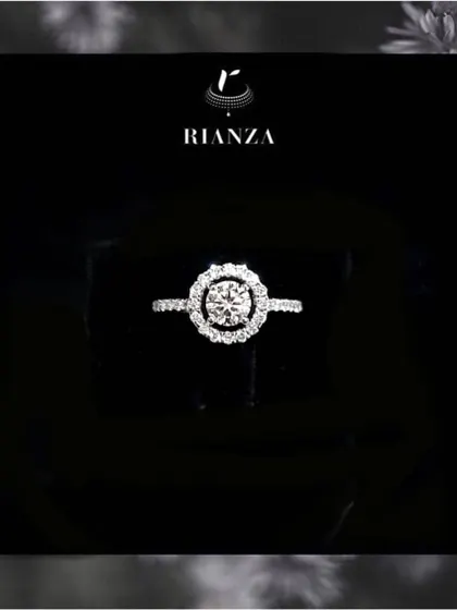 A classic that never fades. This round solitaire diamond ring, set in a halo of smaller diamonds, is a testament to timeless design and is a perfect choice for an engagement or a special anniversary.
