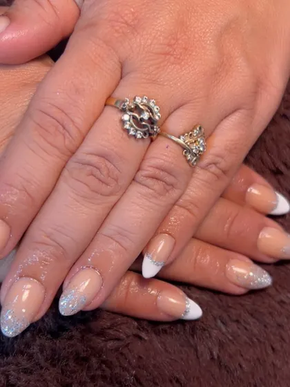 A beautiful combination of a classic white French tip with a silver glitter fade. This is a perfect look for weddings or any festive occasion.