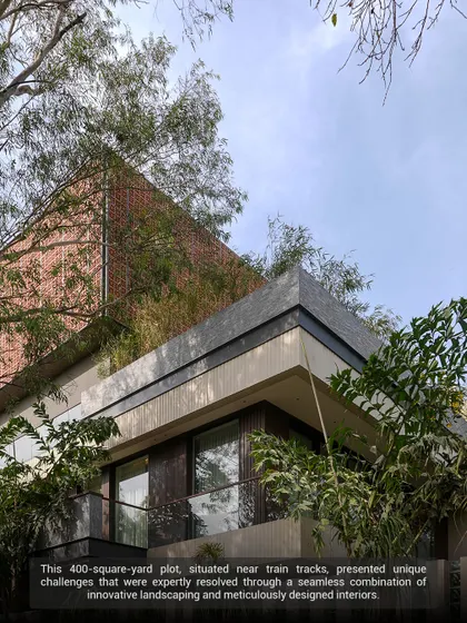 This 400-square-yard plot, once a timeworn bungalow, was revitalized into a luminous sanctuary. The design uses innovative landscaping with dense perimeter planting to buffer noise from nearby train tracks, creating a peaceful urban oasis.