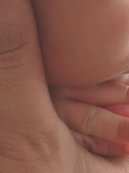 A macro detail shot of a baby's tiny hand wrapped around their parent's finger. It’s a simple but incredibly powerful image that speaks volumes about love and connection.