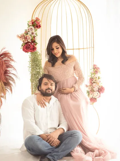 A relaxed and loving portrait of the couple. The mom-to-be leans on her partner, creating a sense of comfort and togetherness.