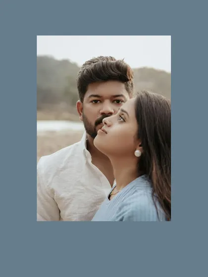 An artistic and moody portrait of a couple, framed in a cool blue tone.