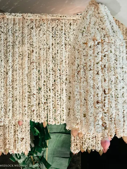An enchanting chandelier made entirely of fragrant jasmine (mogra) and delicate pink lotuses. This was a stunning centerpiece for a traditional half-saree function, filling the air with a beautiful scent.