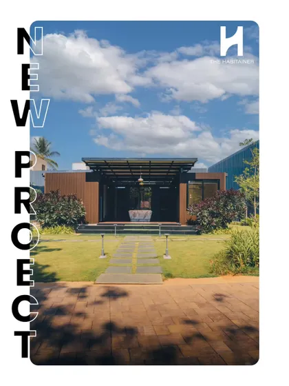 Announcing our new twin container office project. This head-on shot shows the building's strong symmetry and inviting entrance, set in a manicured lawn. It's a perfect example of a compact yet impactful workspace.