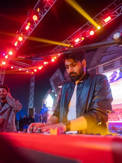 Mithoon at his keyboard during the Gopalpur Beach Festival, with the stage and lighting visible.