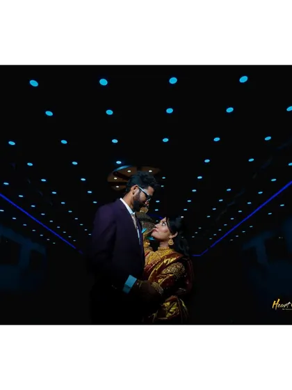 A creative shot of the couple in a modern setting with dramatic blue lighting, creating a futuristic and cool vibe.