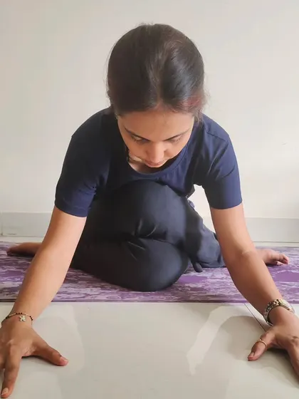 A student in Pigeon Pose (Eka Pada Rajakapotasana), a deep hip-opener common in Yin Yoga. This practice helps release stored tension and emotion.